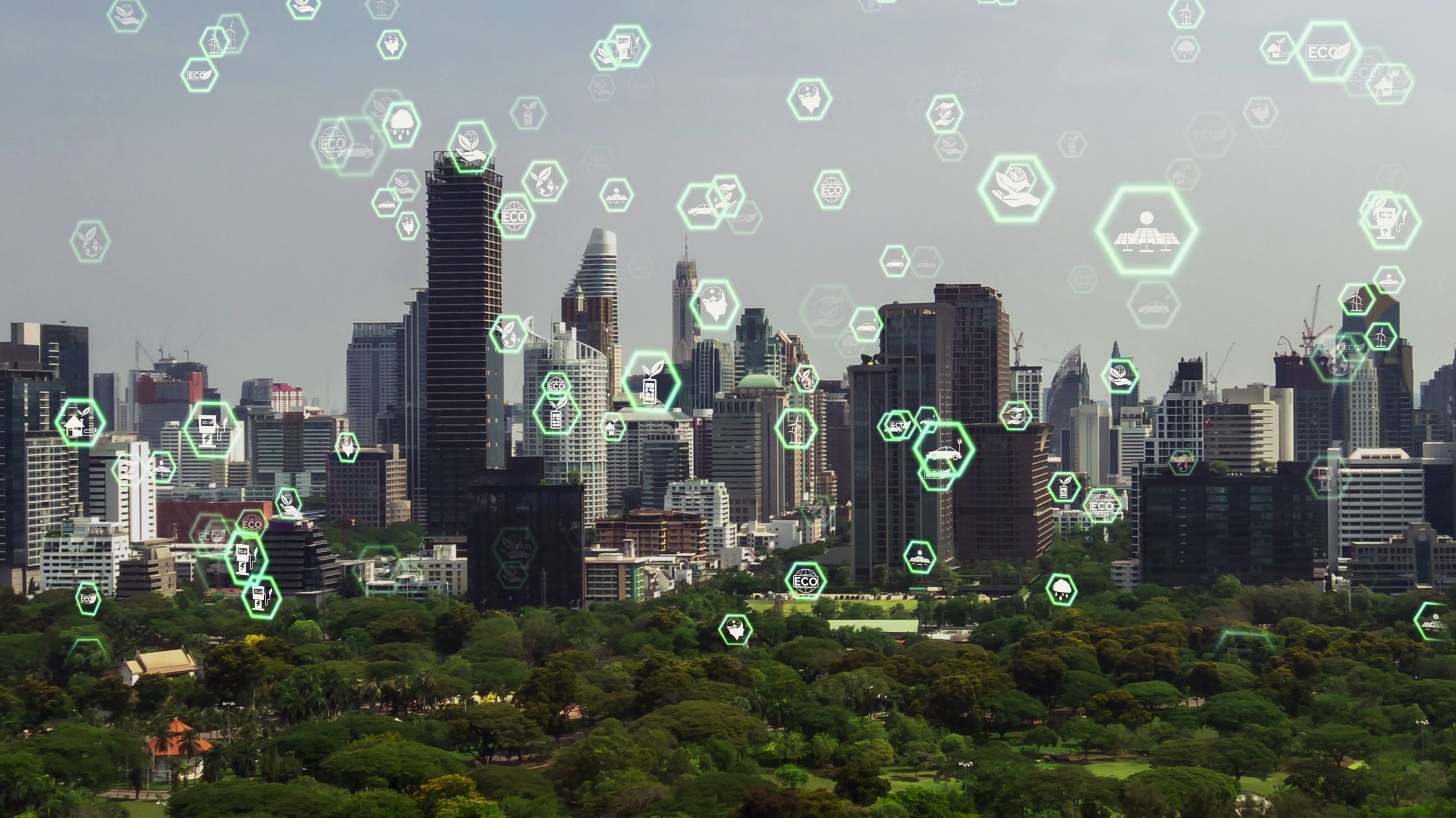 A large city with green space and an overlay of icons showing digital transformation initiatives.